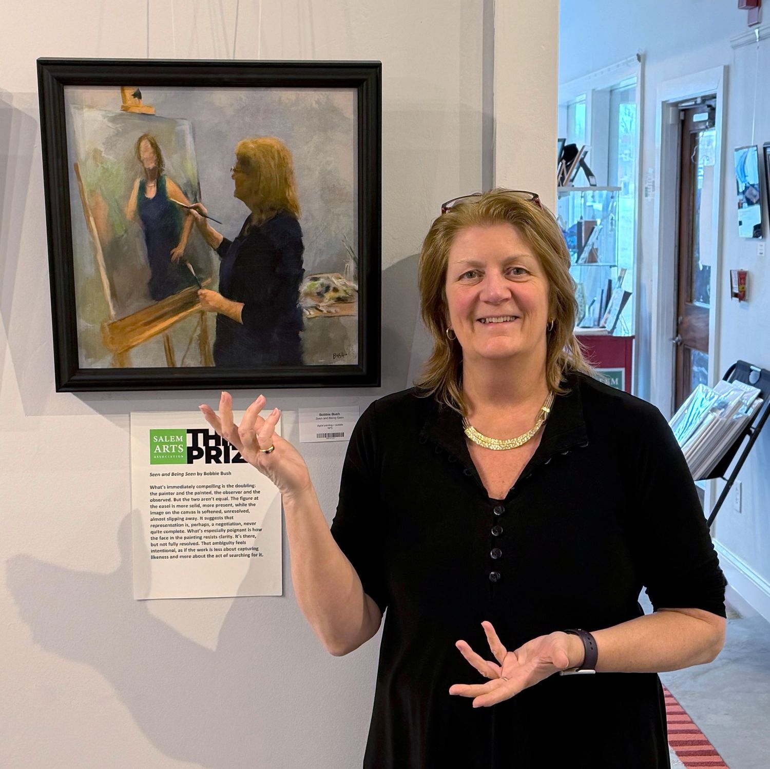 Bobbie Bush at the Faces & Facades group show with her painting 