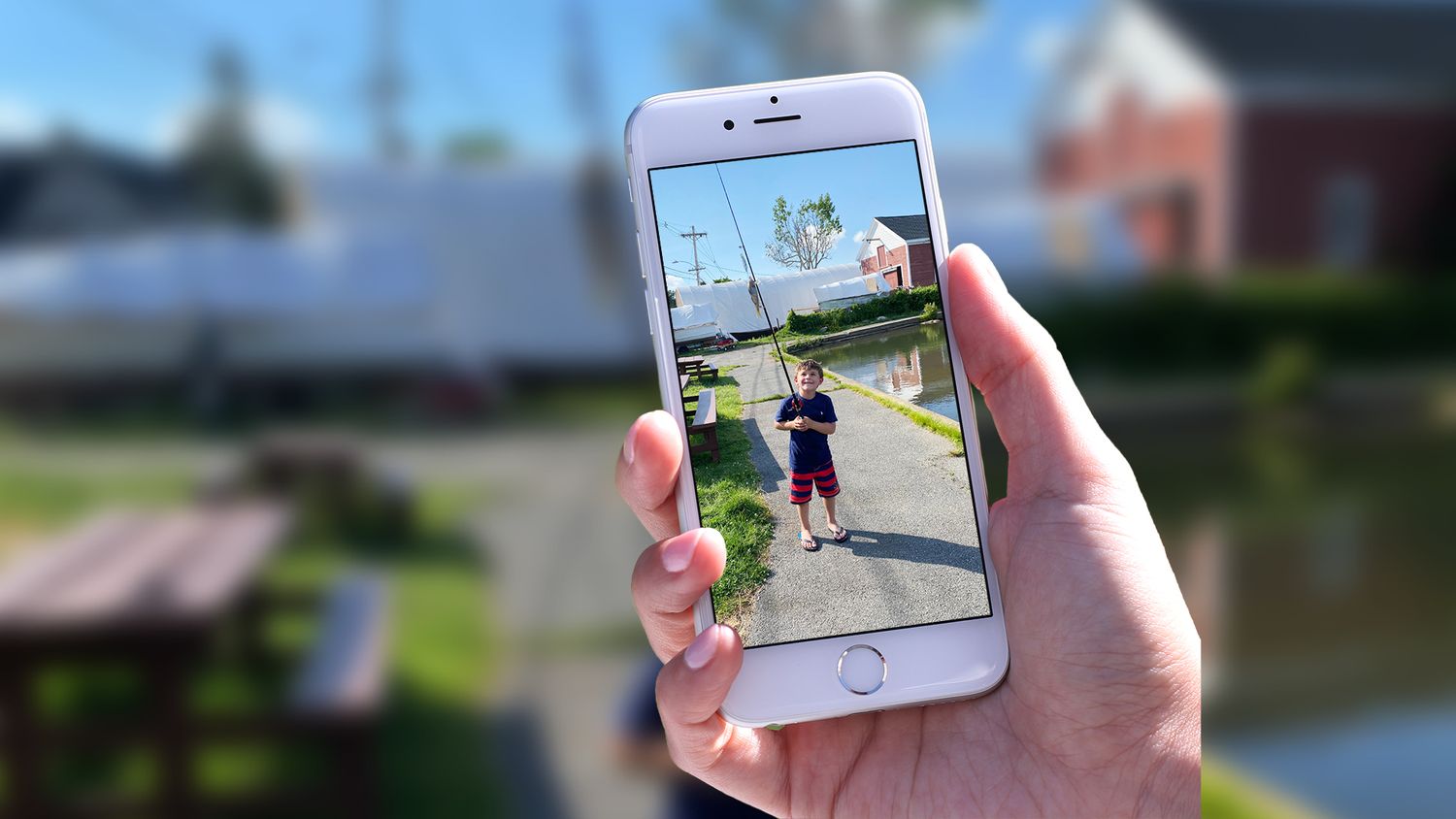 iPhone camera roll photo of a boy fishing, later transformed into a painting commission.