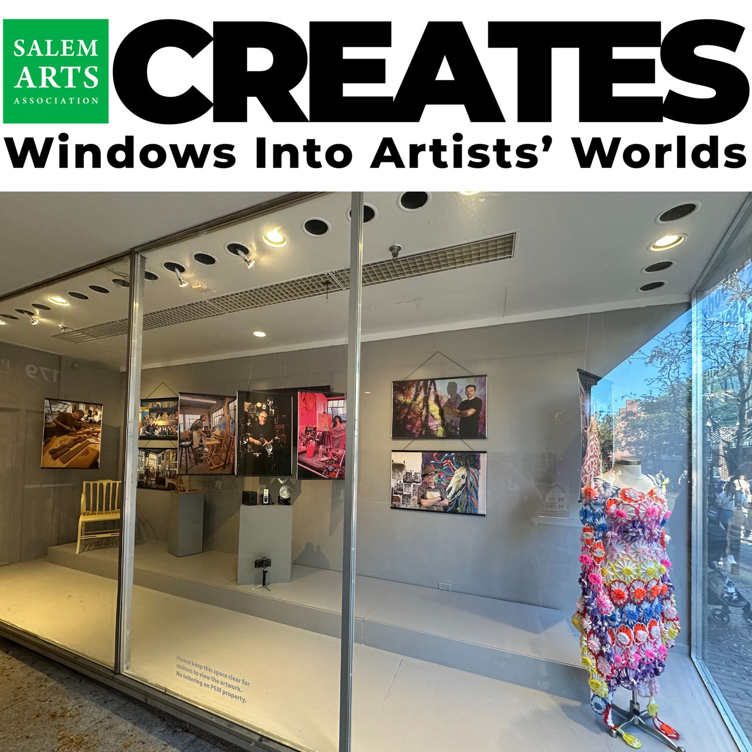 Portraits of Salem artists displayed in storefront windows near Peabody Essex Museum.