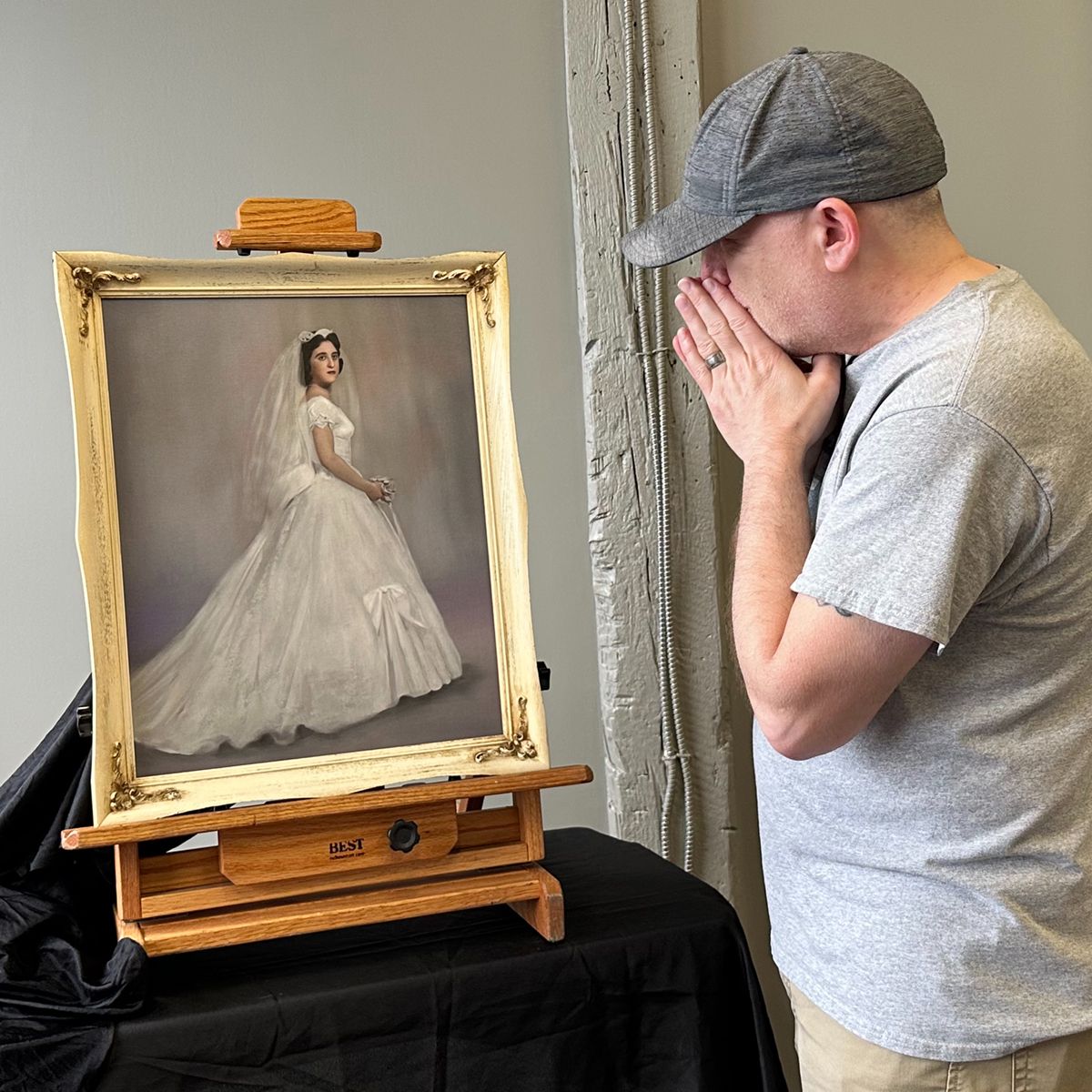 An emotional response when a client first sees the bridal portrait painting restoration.