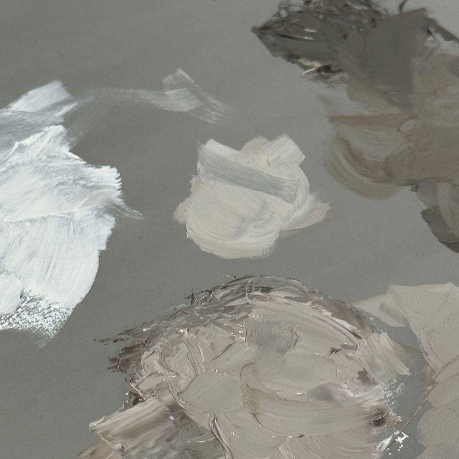 Gray and white paint on a palette.