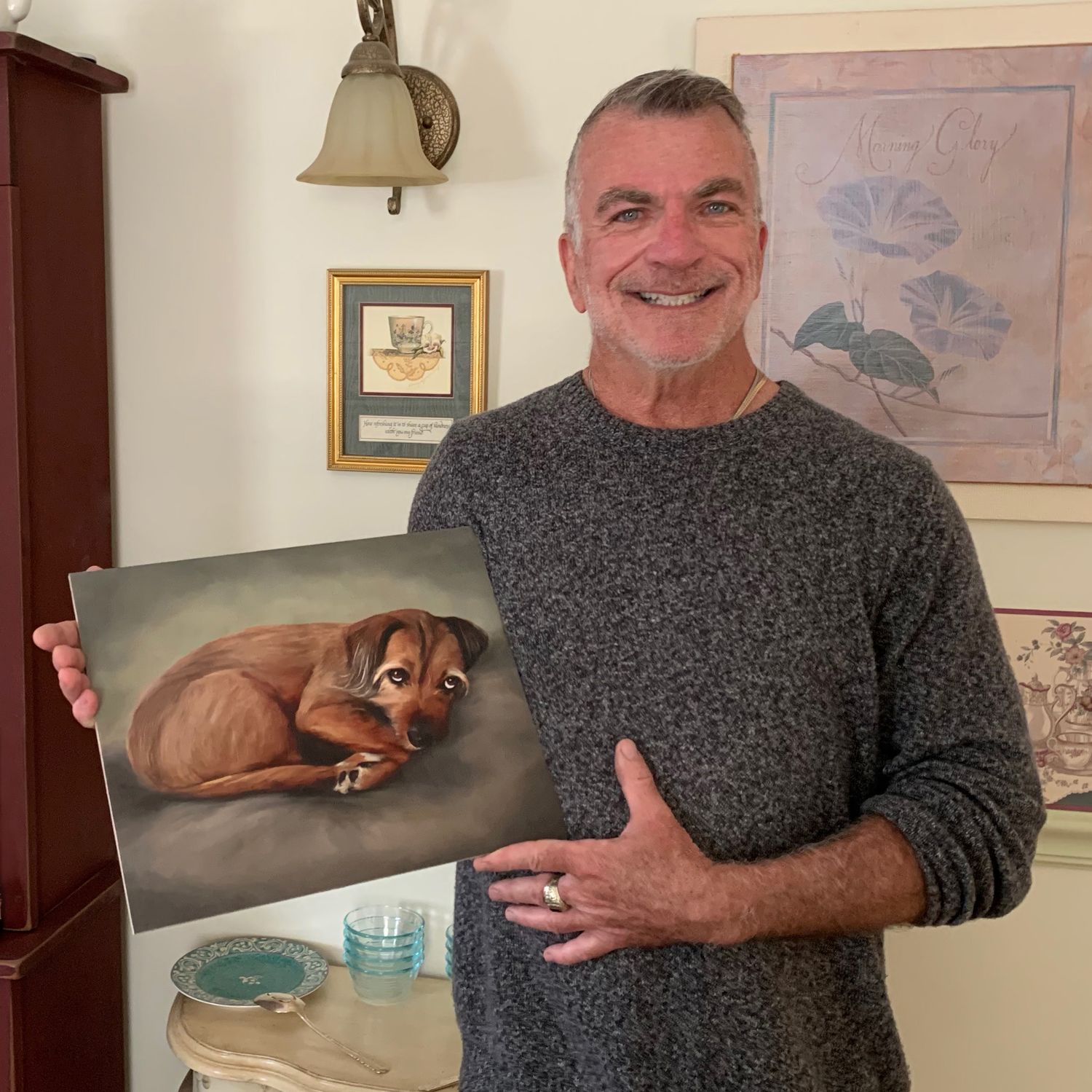 A client proudly holding his finished pet portrait commission.