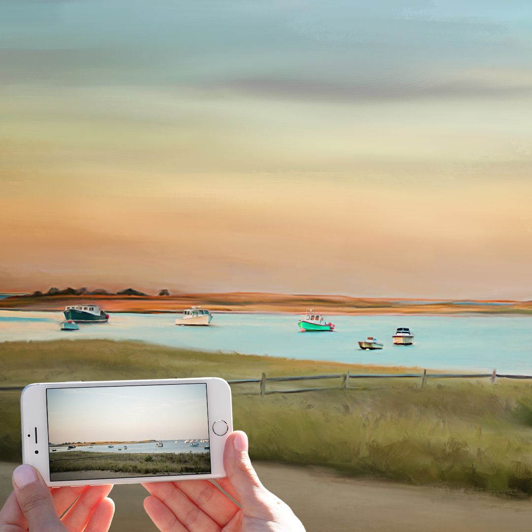 Landscape painting of boats in water with phone capturing scene during sunset.