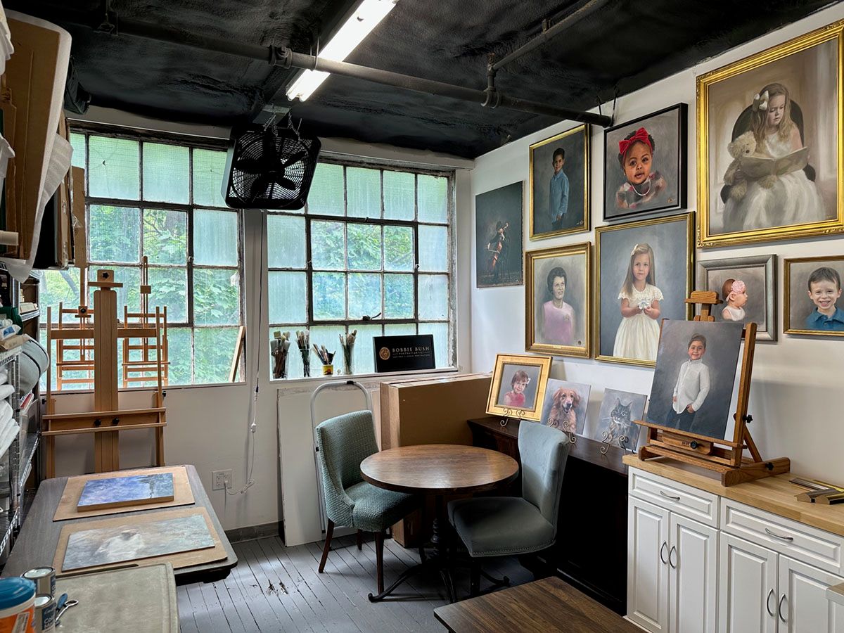 Bobbie Bush's studio interior at Gallows Hill Artists studio in Salem MA. Filled with portrait samples and large windows.