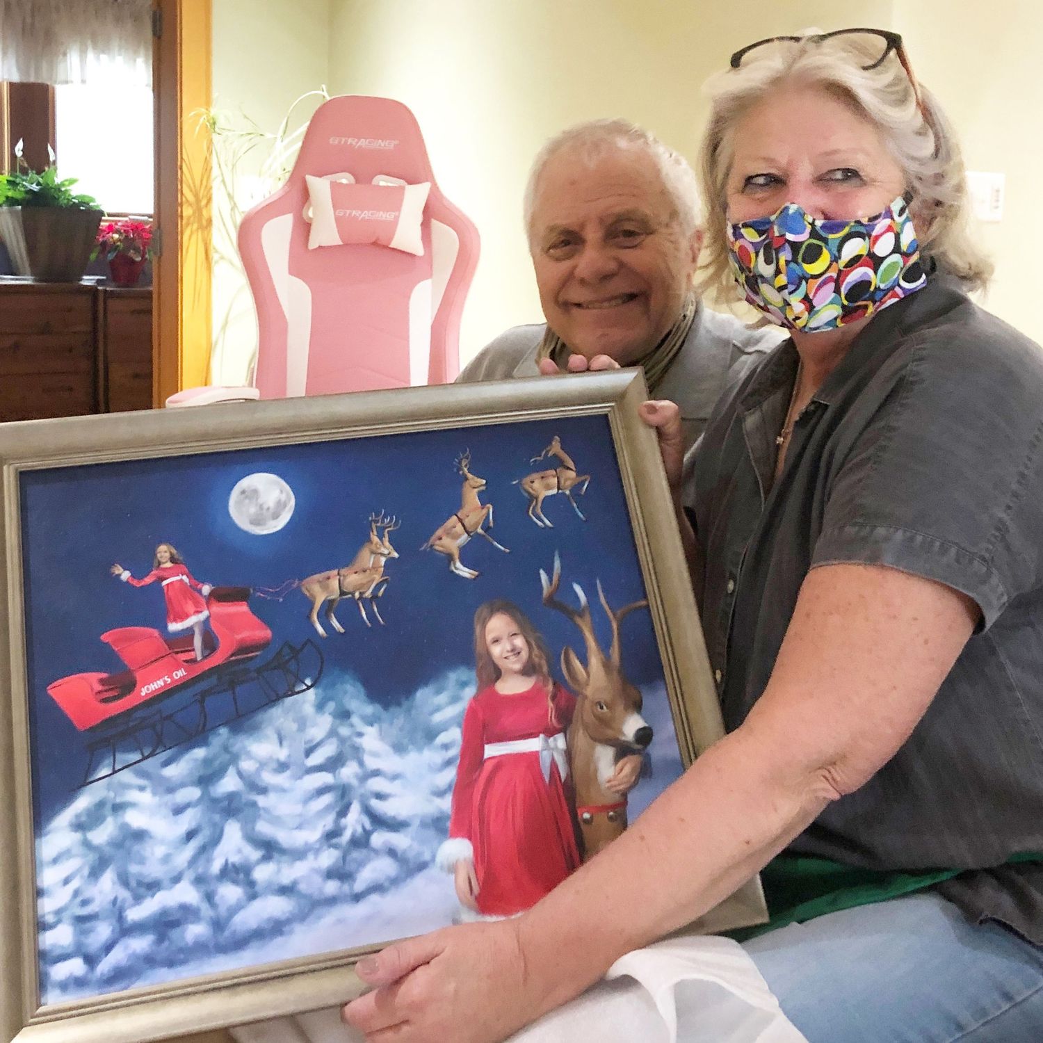 Custom commission being gifted. Happy faces with their custom art of their granddaughter on Santa's sleigh in a moonlight scene.