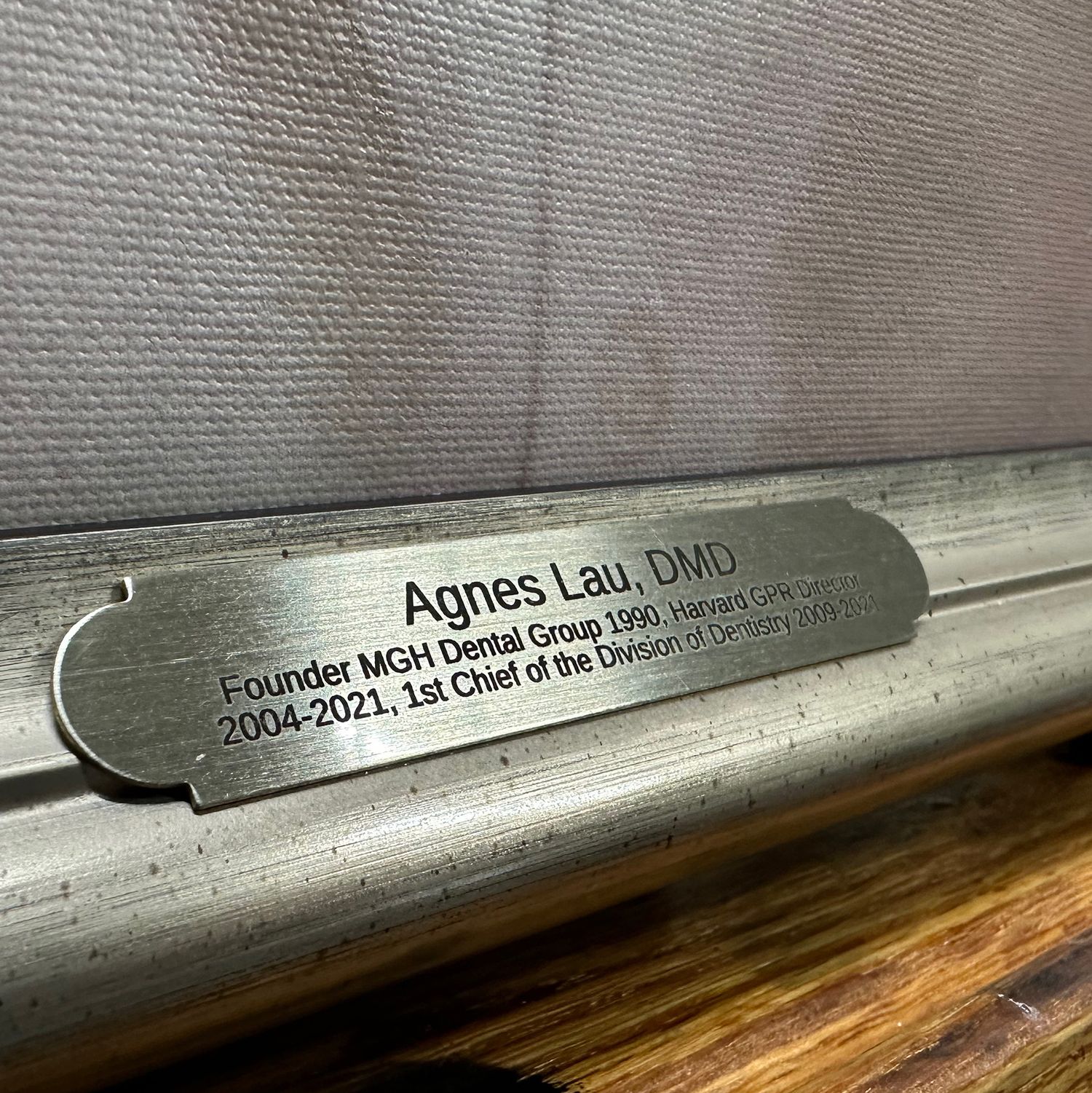 Engraved brass nameplate on the frame for a special portrait painting honoring a retired colleague.