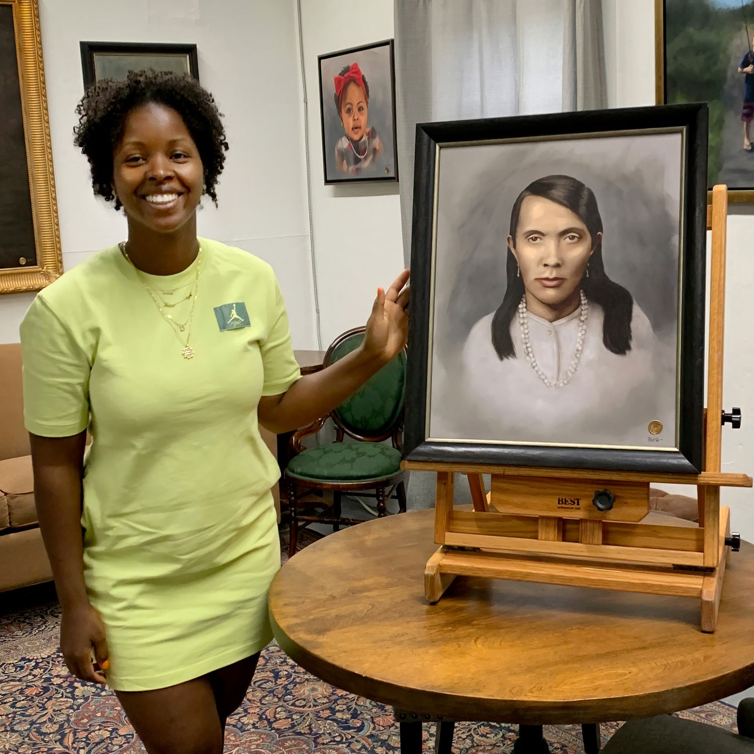 A very happy client, seeing the finished portrait of her mother in law on the easel.