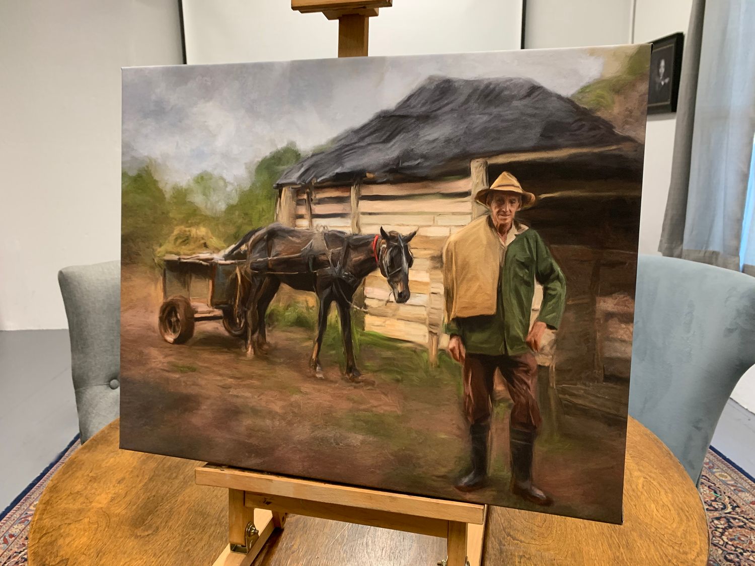 Finished stretched canvas painting on easel of a personal travel inspired painting of a Cuban farmer on his tobacco farm. .