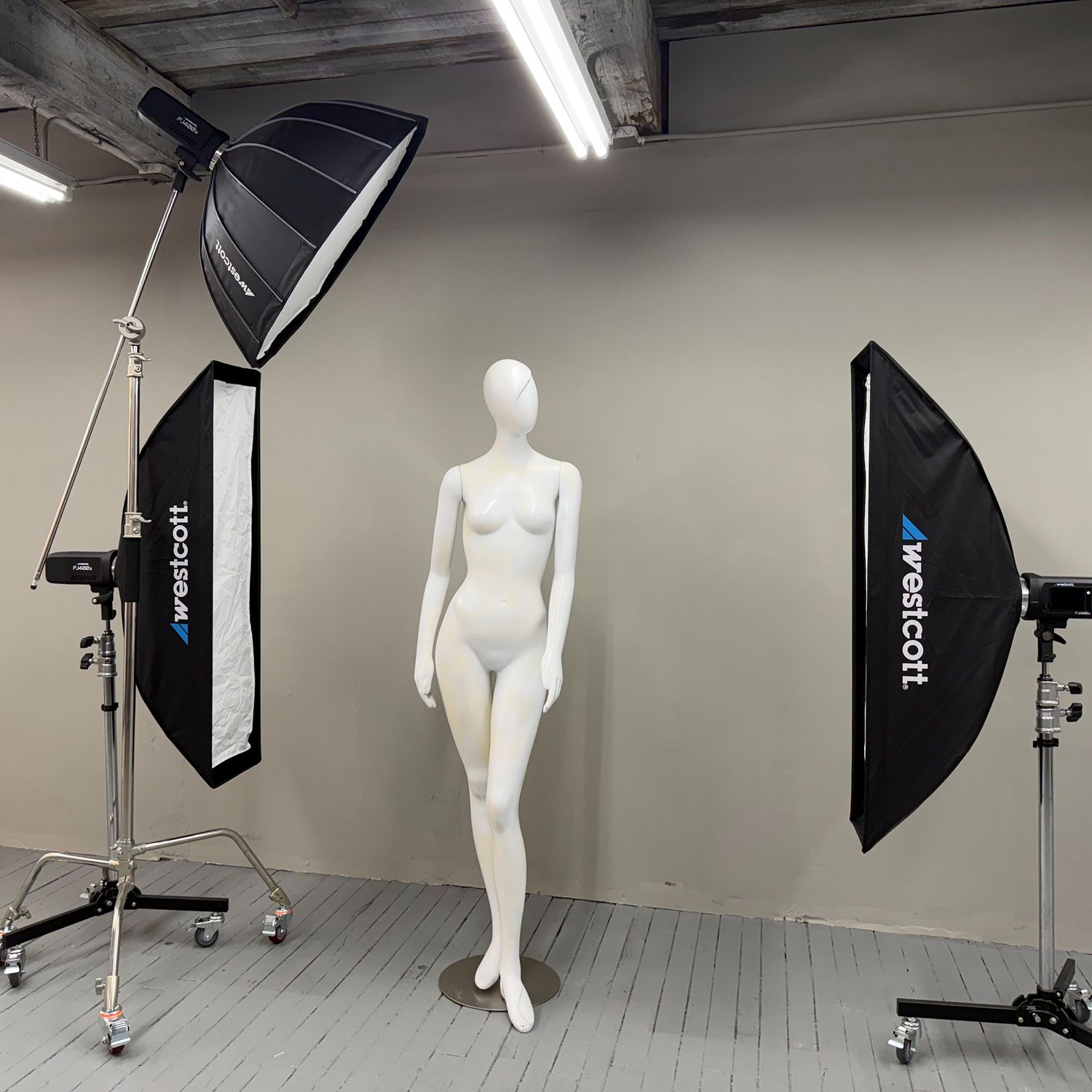 Gallows Hill Artists studio interior, with a photographer's lighting and a mannequin in an artists studio. In Salem MA.