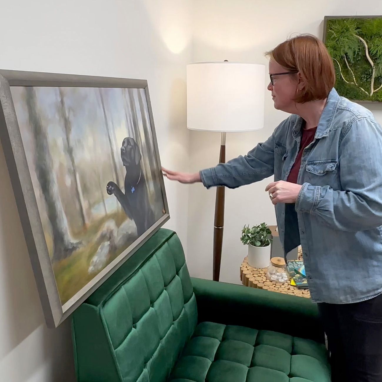 A client is emotional at the unveiling of the memorial portrait painting of her beloved pet Charlotte.