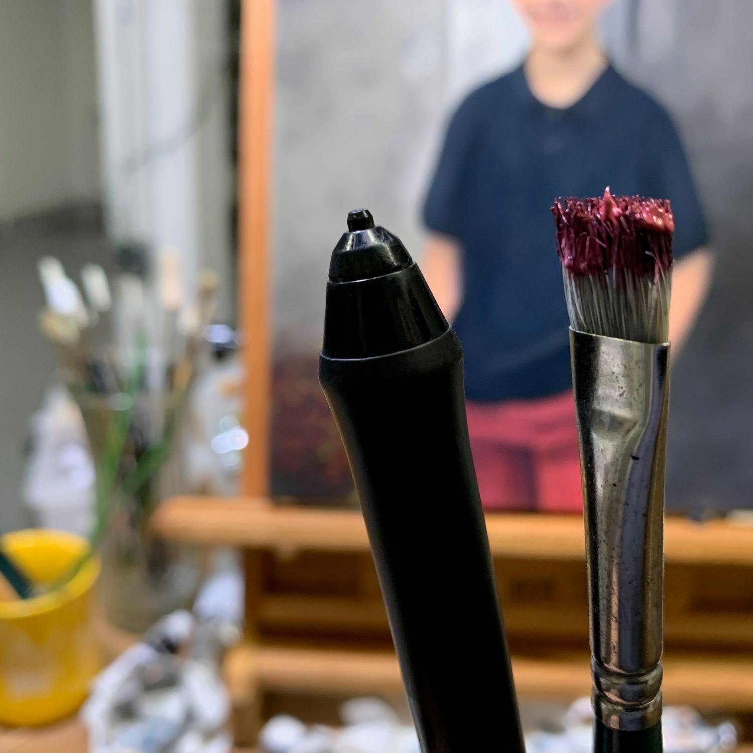Close-up of two brushes, one electronic and one traditional. Both are used by artist Bobbie Bush.