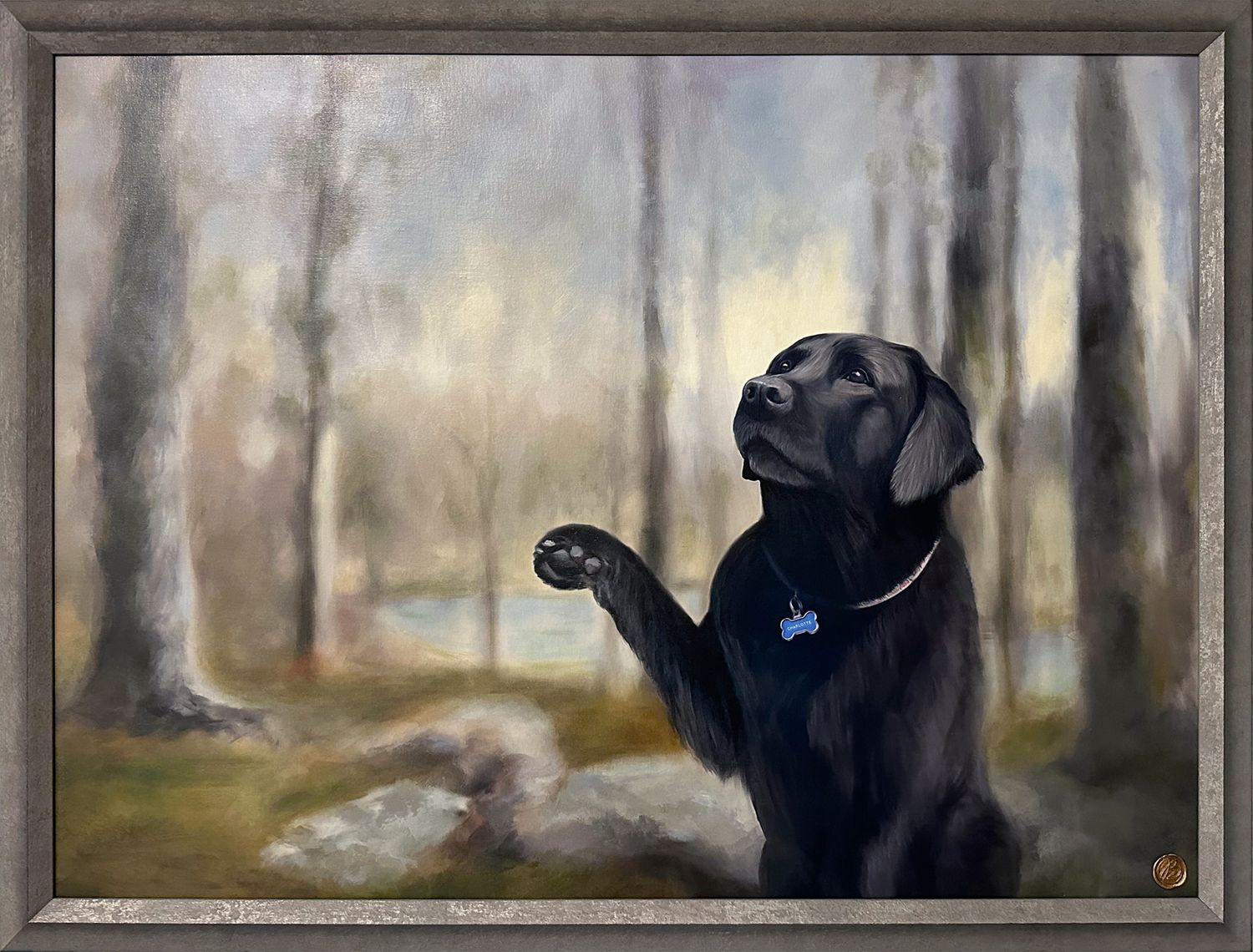 Framed portrait painting of a black Labrador dog seen in a painterly forest setting.