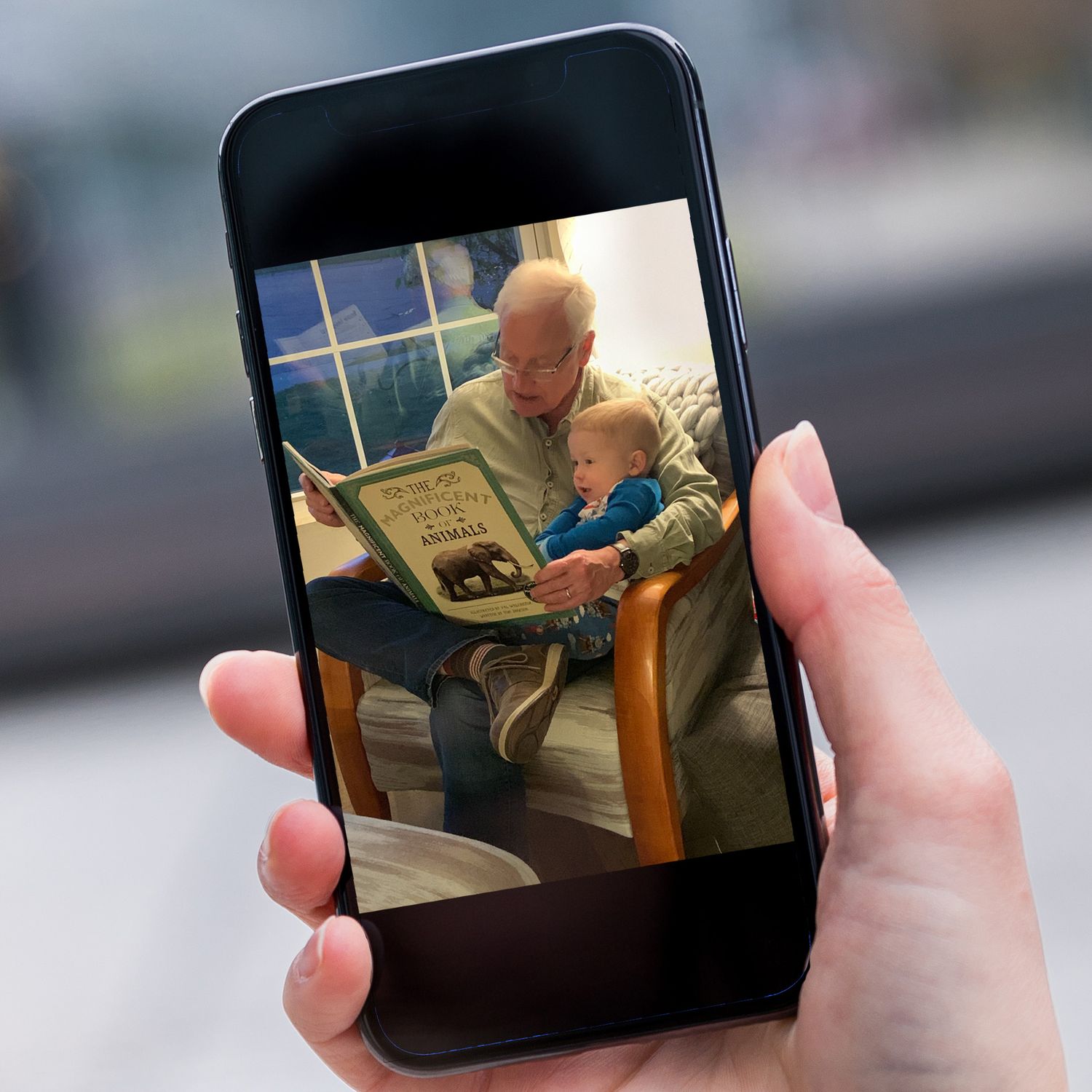 Source photo of a heartwarming moment with a grandfather reading to his grandson. Photo used for a painting commission.