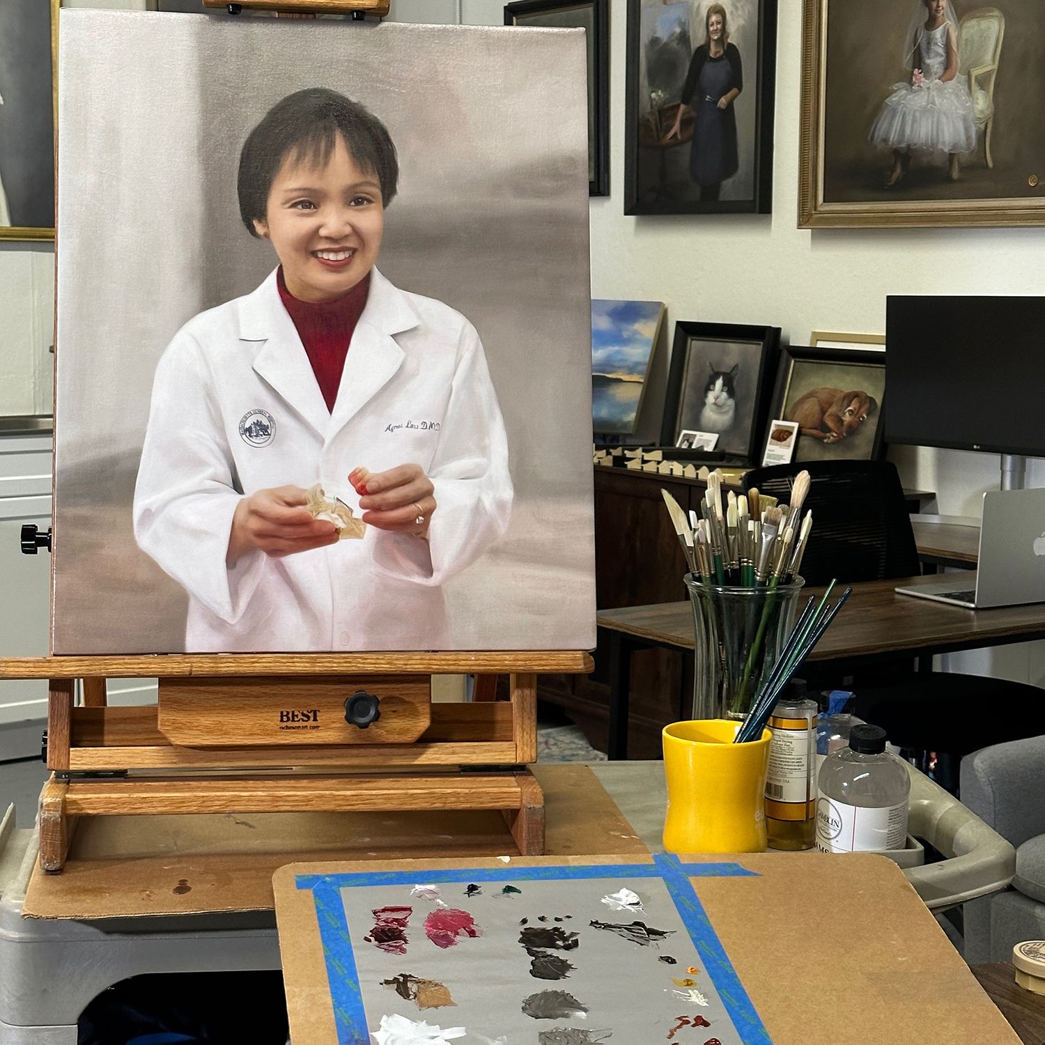 Work in progress of a painted portrait of physician Dr Agnes Lau, on the easel.