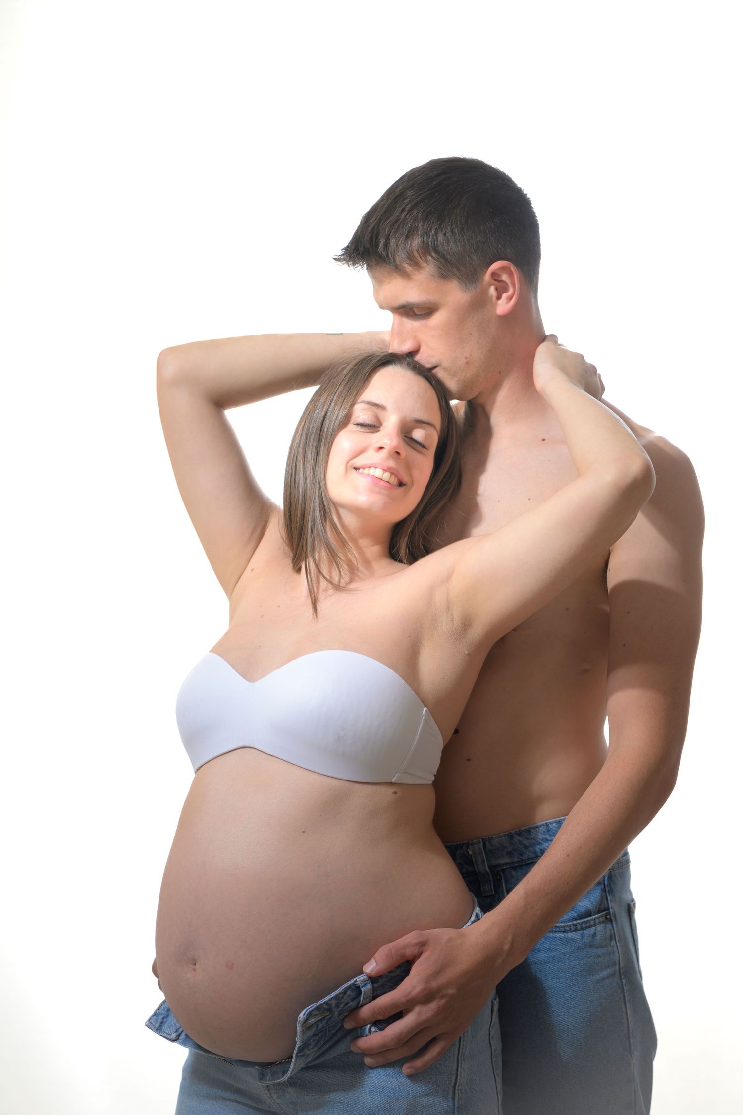 Pregnant woman in white bra and man in jeans embrace in three intimate maternity photos against white background.