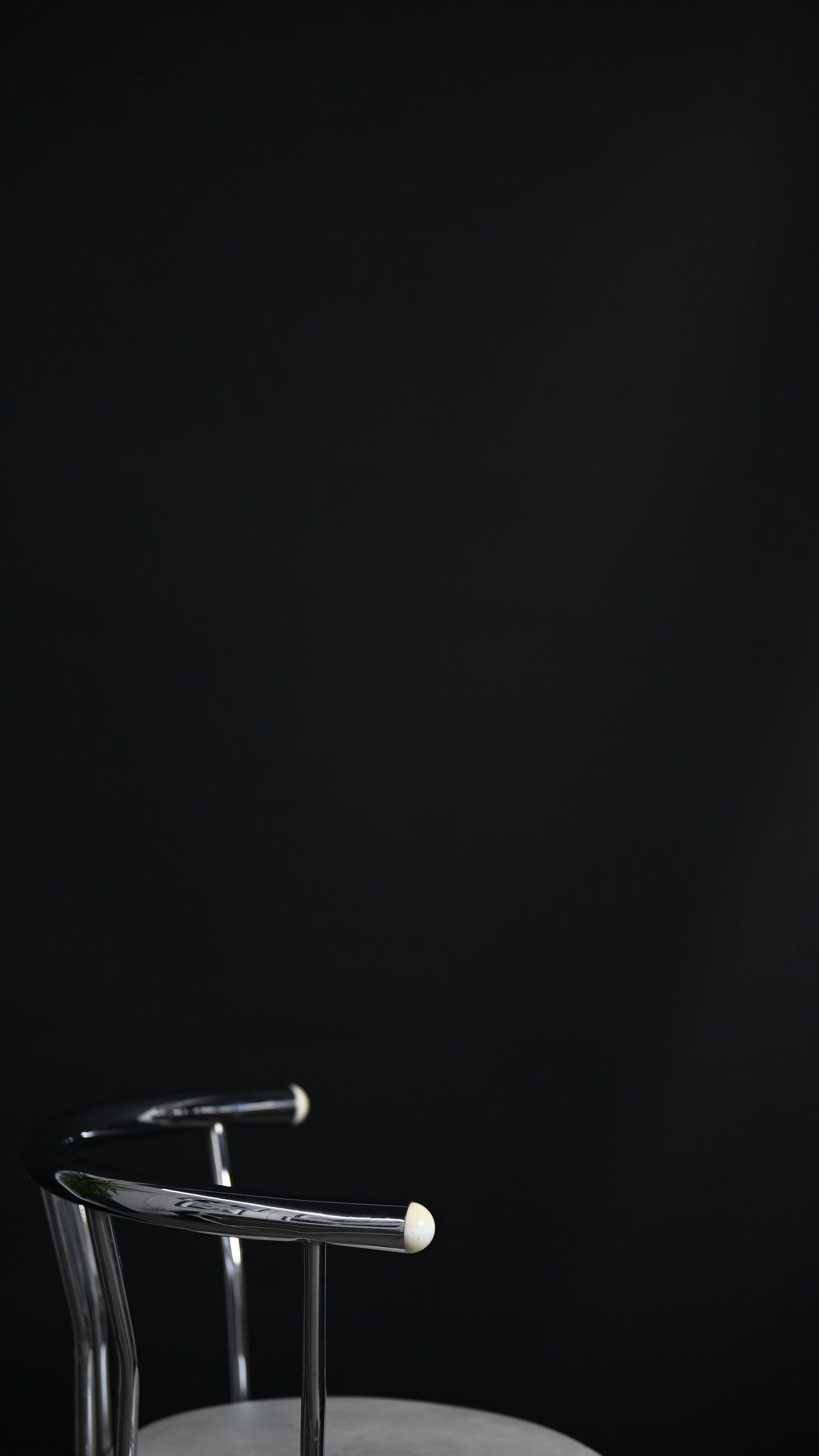 Three lit cigarettes arranged in a minimalist composition against a black background.