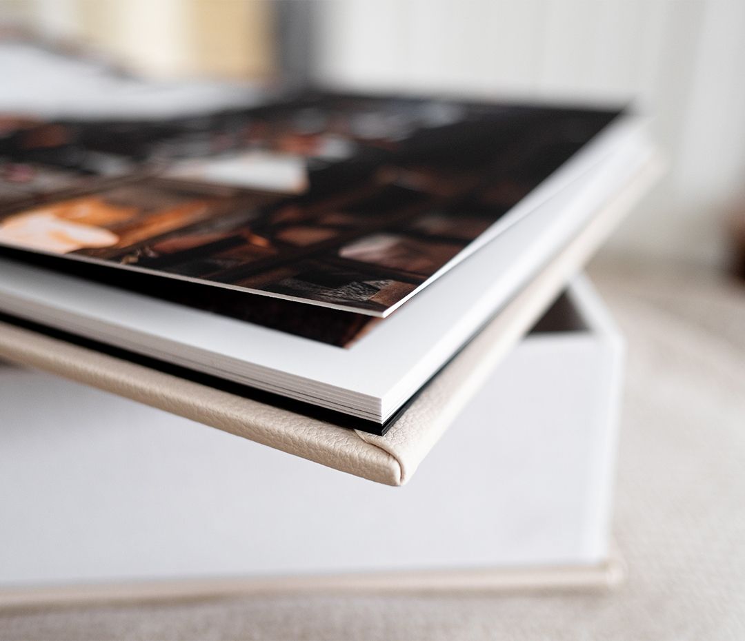 Close-up photo of book pages and binding against a white background creating depth and shadow.