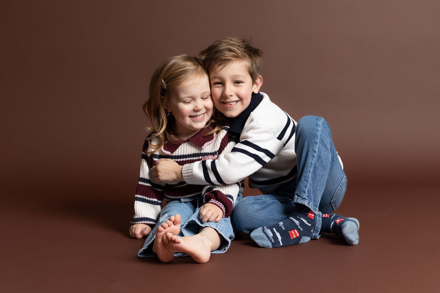 A photograph of two siblings enjoying a heartfelt moment captured in a family photography studio near Telford