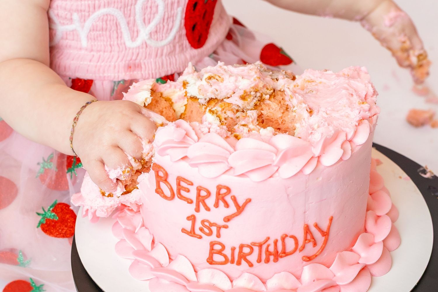 1 year old close up smashes into pink frosted cake during 1st birthday photos with brand &family photographer, Annie Robinson Photography.