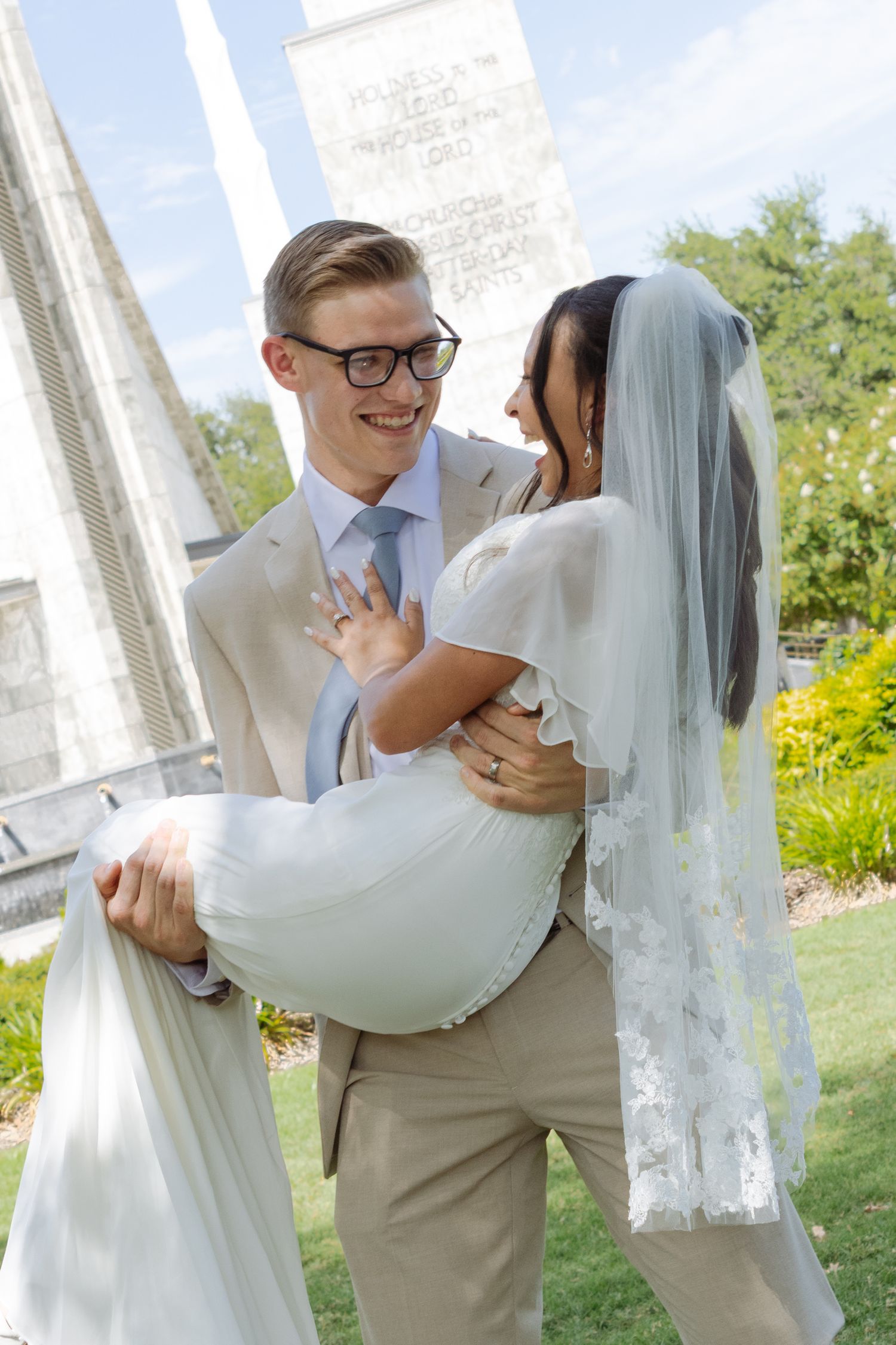 A bride and groom hold each other at a church temple in Texas on their wedding day.