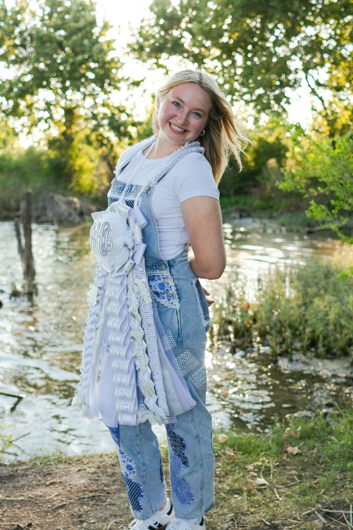 A high school senior poses with her Homecoming mum in Texas.