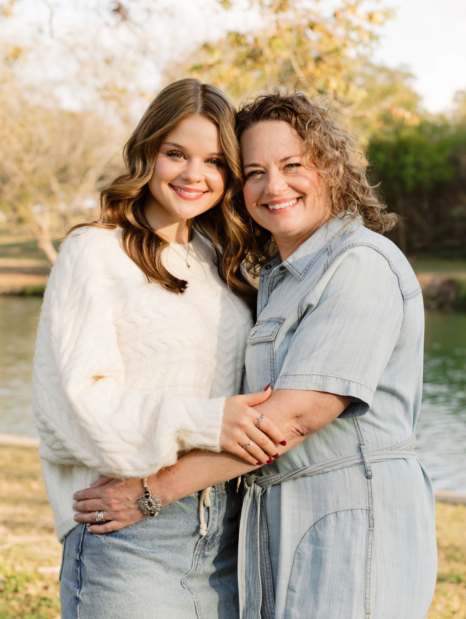 A mom and daughter smile during a photo shoot at San Gabriel Park in Georgetown, Texas.