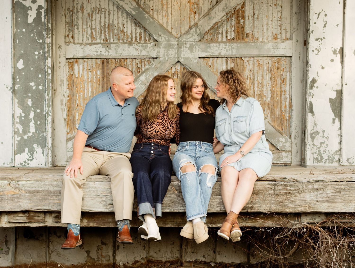 A family smiles during a photo shoot at an abandoned building in Georgetown, Texas.