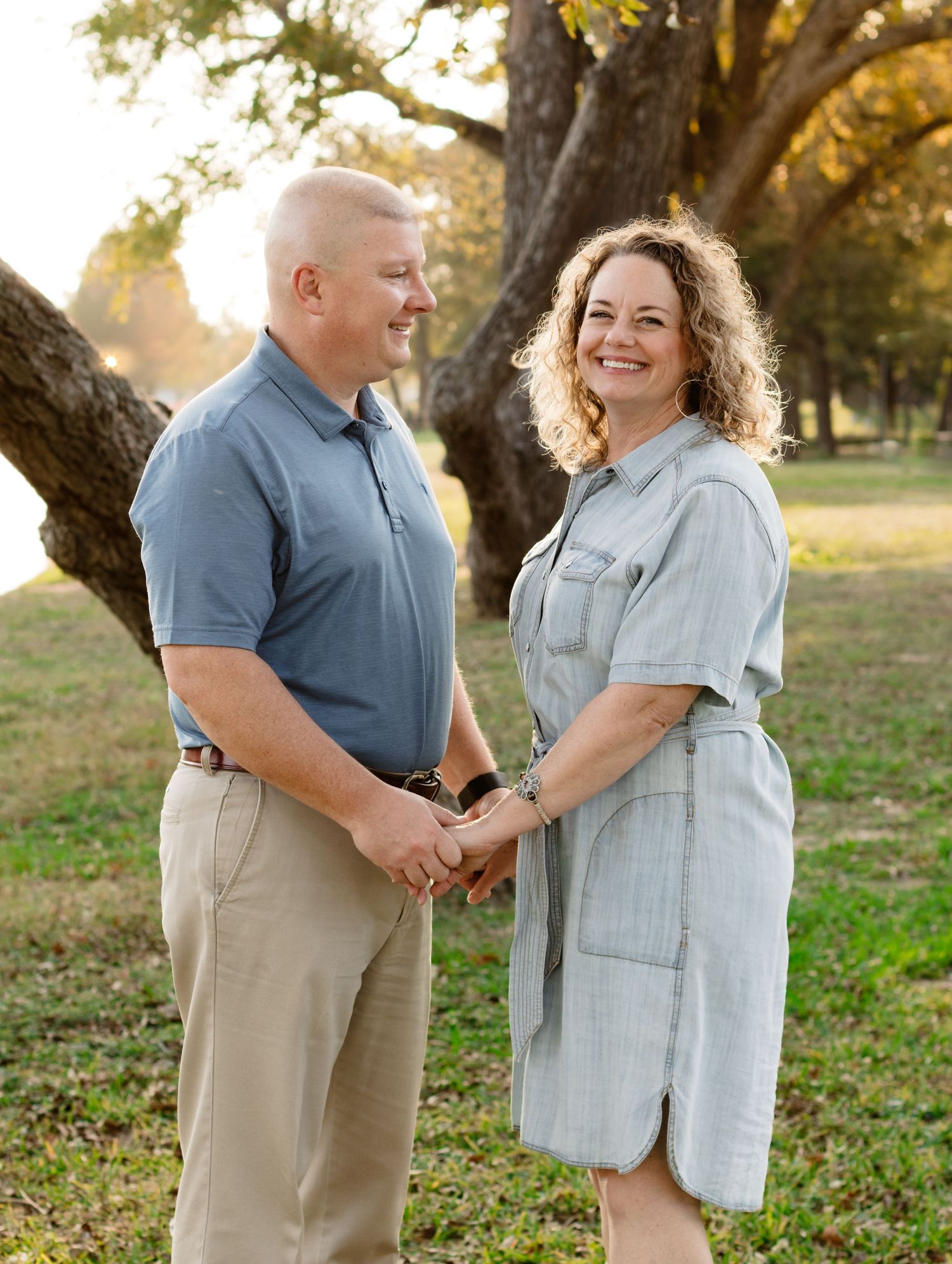 A husband and wife smile during a photo shoot at San Gabriel Park in Georgetown, Texas.