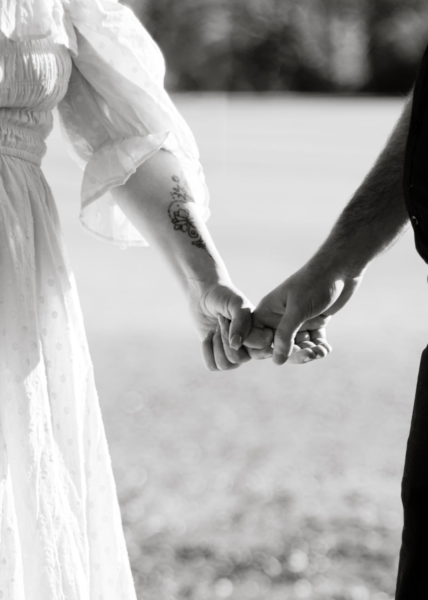 A couple holds hands at a park near Austin, Texas.