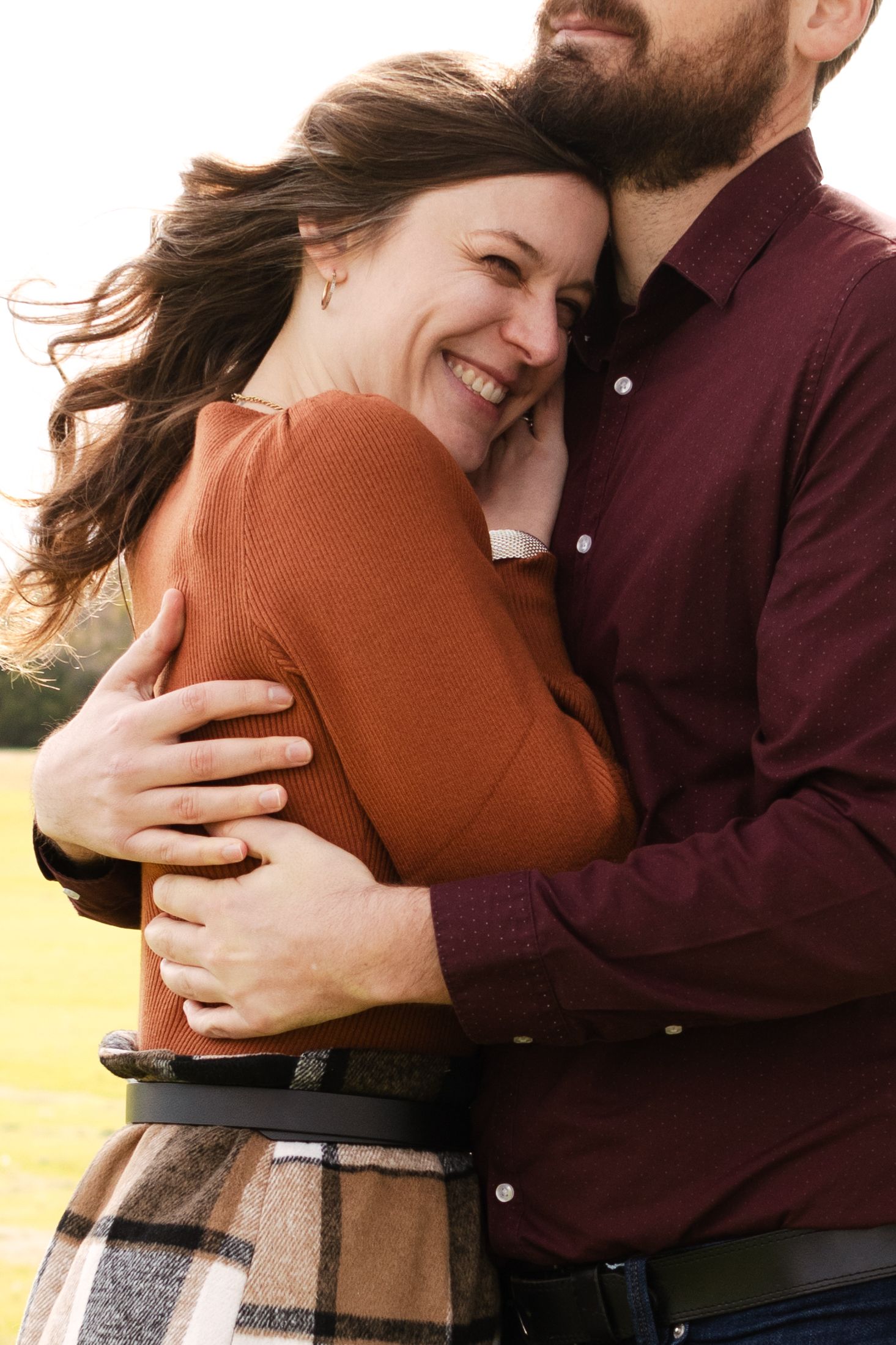 A couple holds each other and laughs at a park near Austin, Texas.