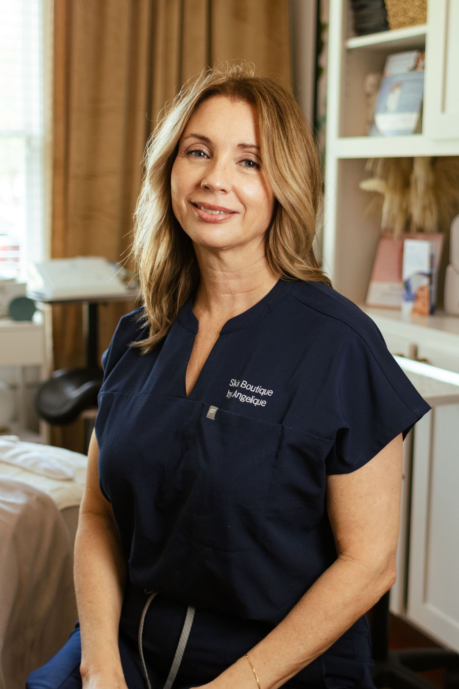 An esthetician poses for a professional headshot in her boutique salon in Georgetown, Texas.