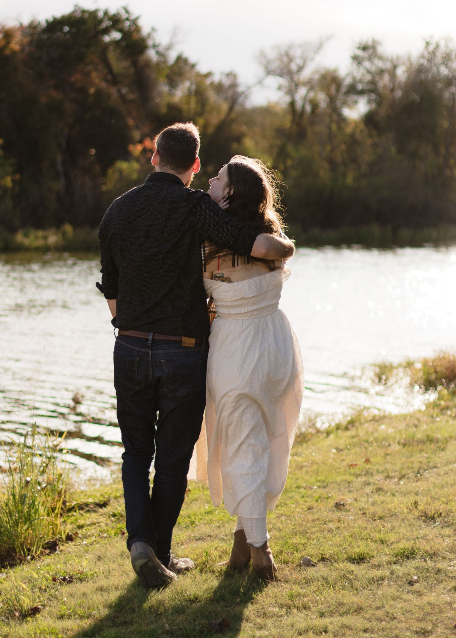 A couple walks together near a lake in Austin, Texas.