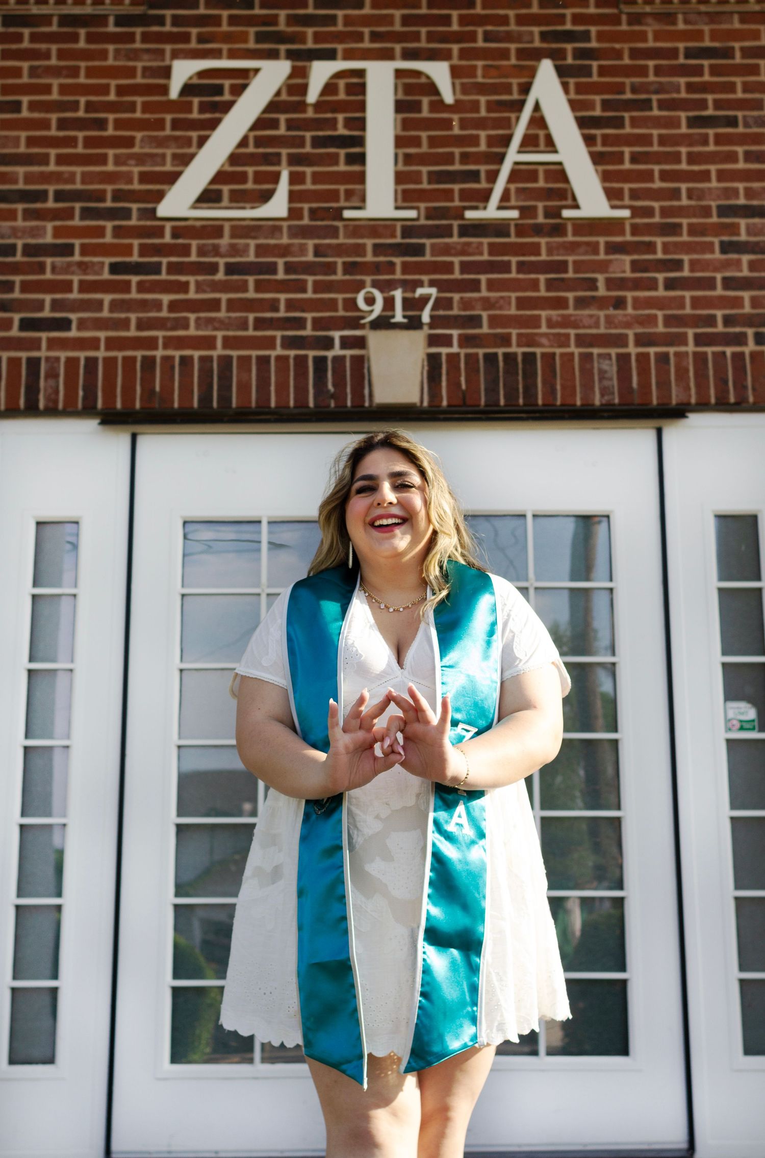 A college student wears her graduation memorabilia on campus.