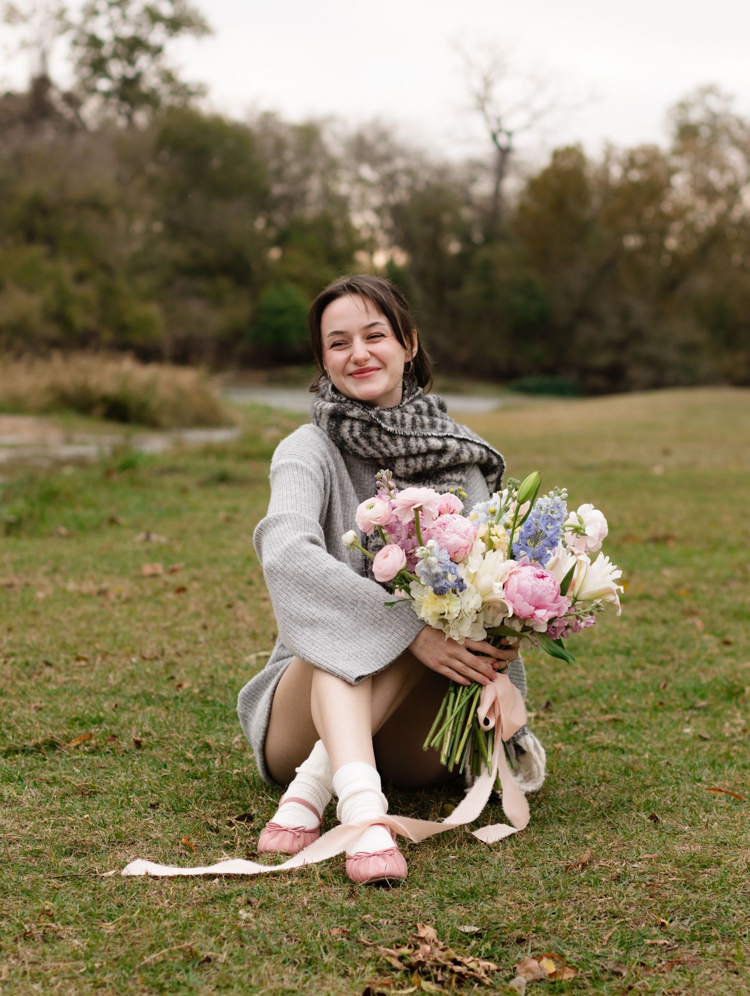 An Austin and Bastrop florist holds a bouquet while posing for a branding photo in Bastrop, Texas.