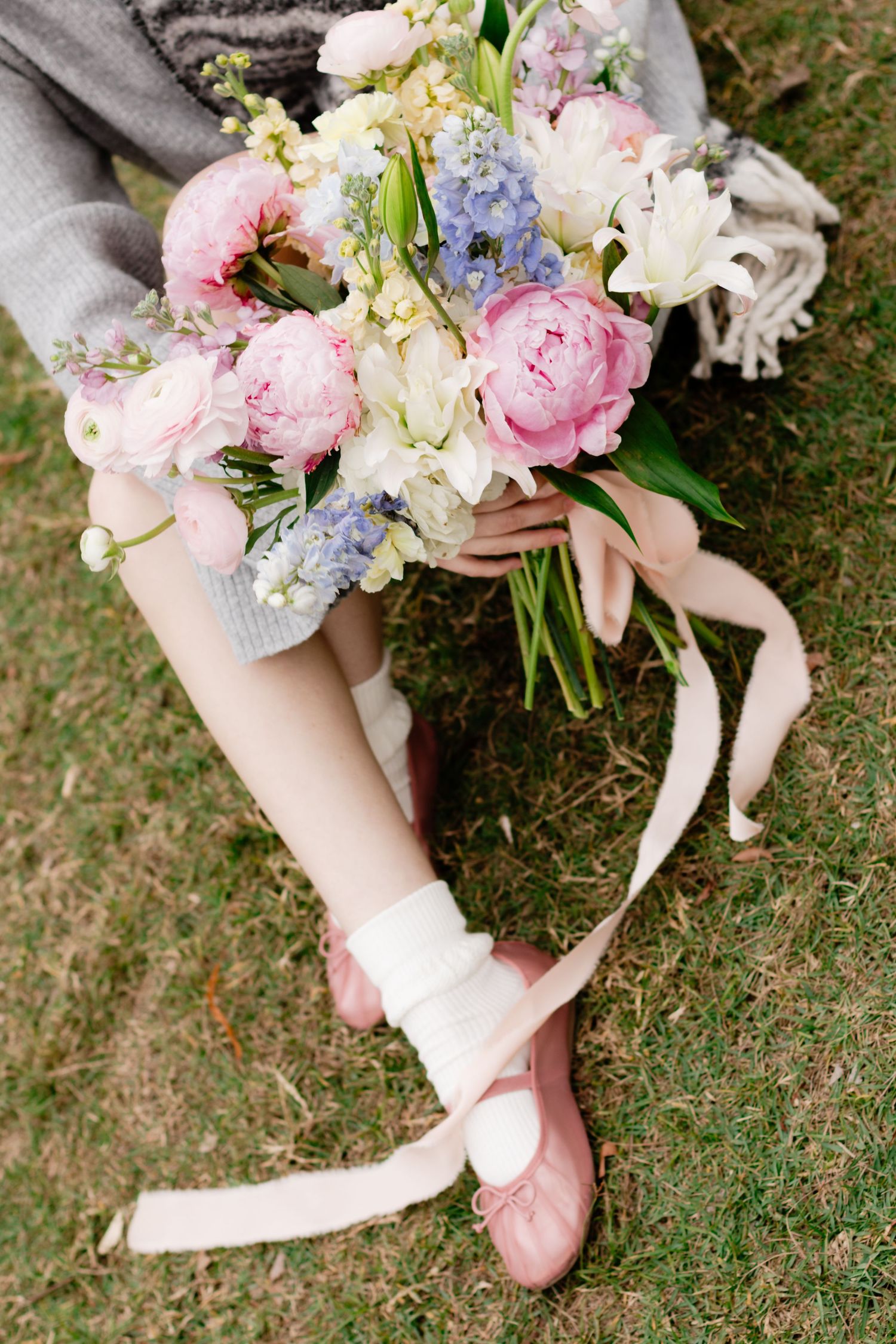 An Austin and Bastrop florist holds a bouquet while posing for a branding photo in Bastrop, Texas.