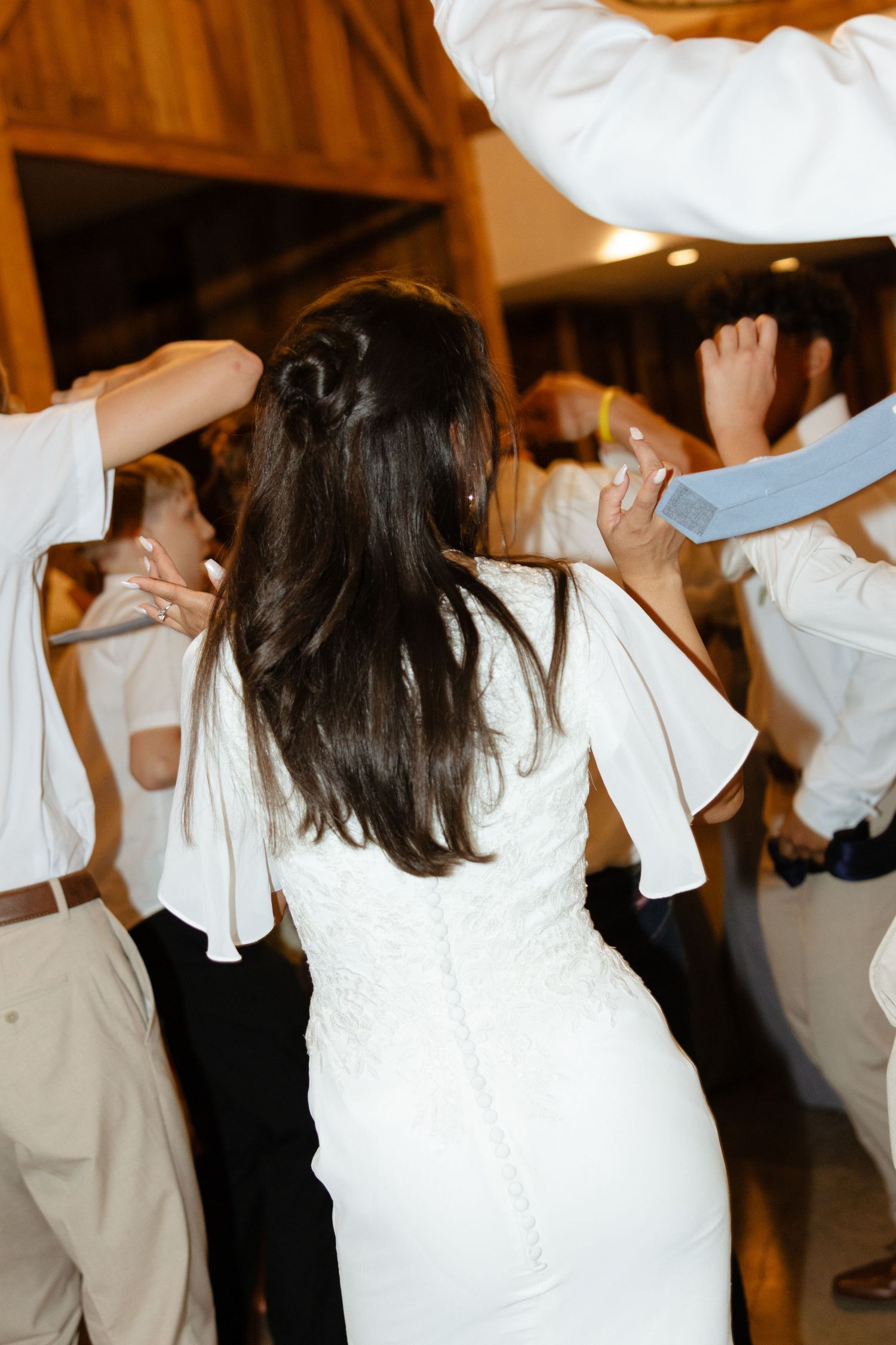 A bride dances during her wedding reception in the Texas summer.