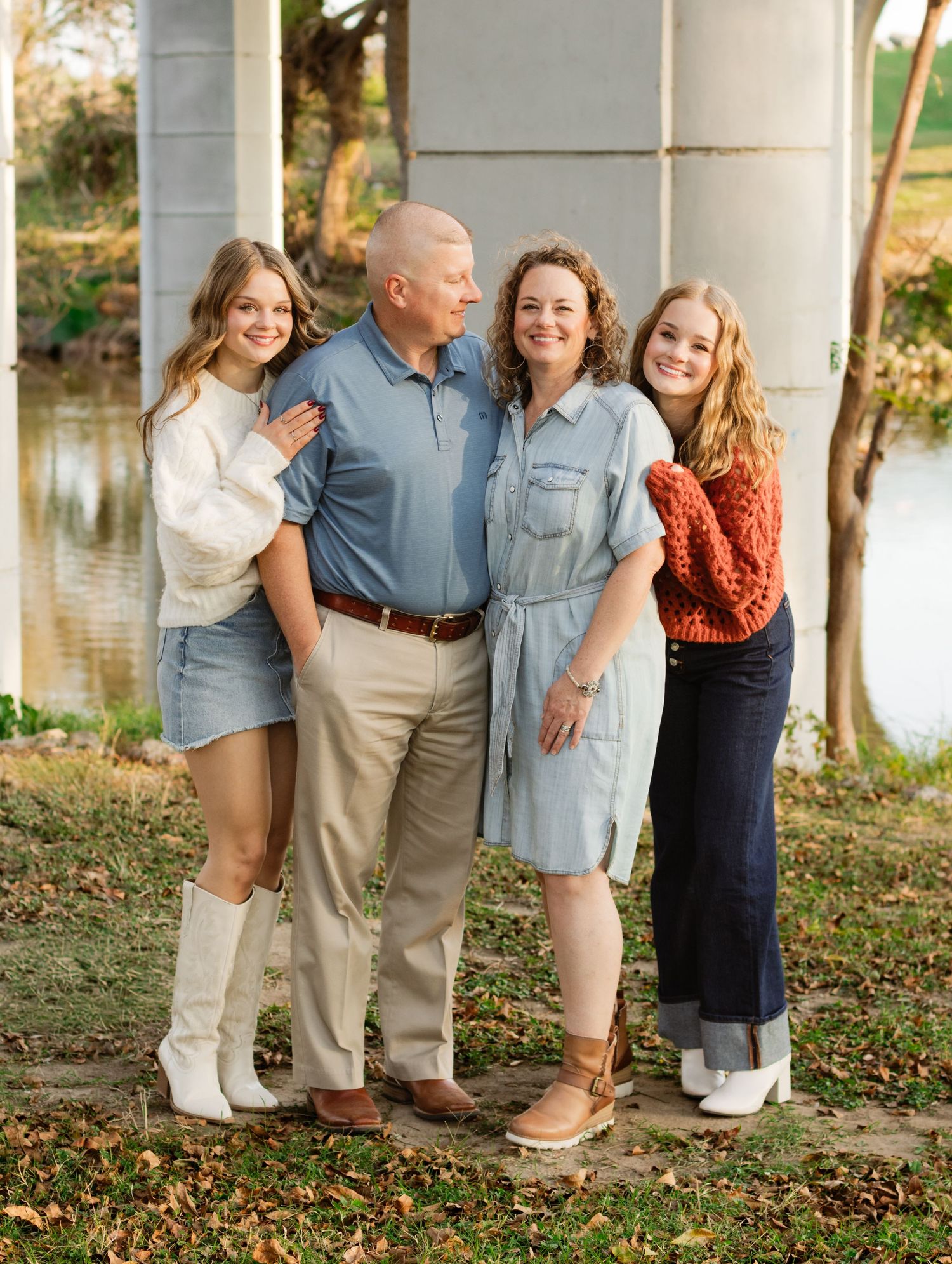 A family smiles during a photo shoot at San Gabriel Park in Georgetown, Texas.
