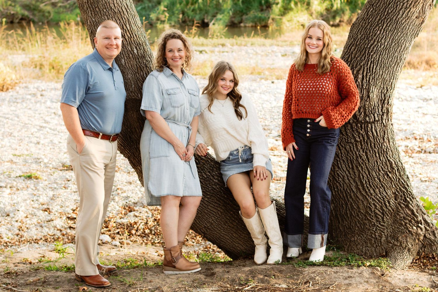 A family smiles during a photo shoot at San Gabriel Park in Georgetown, Texas.