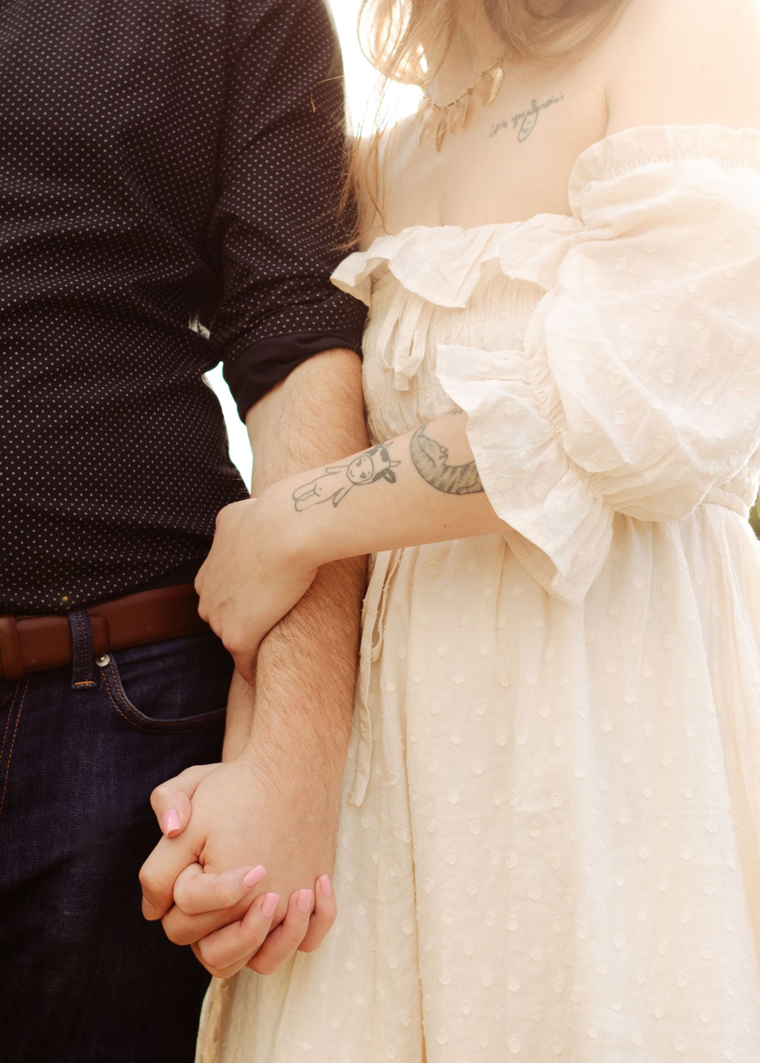 A couple holds hands near a lake in Austin, Texas.