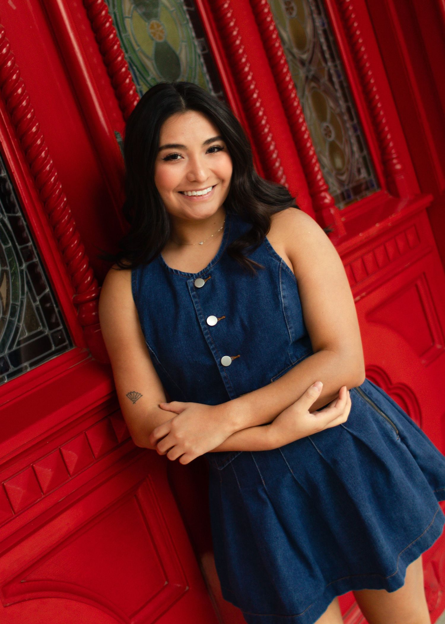A graduating college senior smiles at St. Edward's University in Austin, Texas, during her senior portraits.