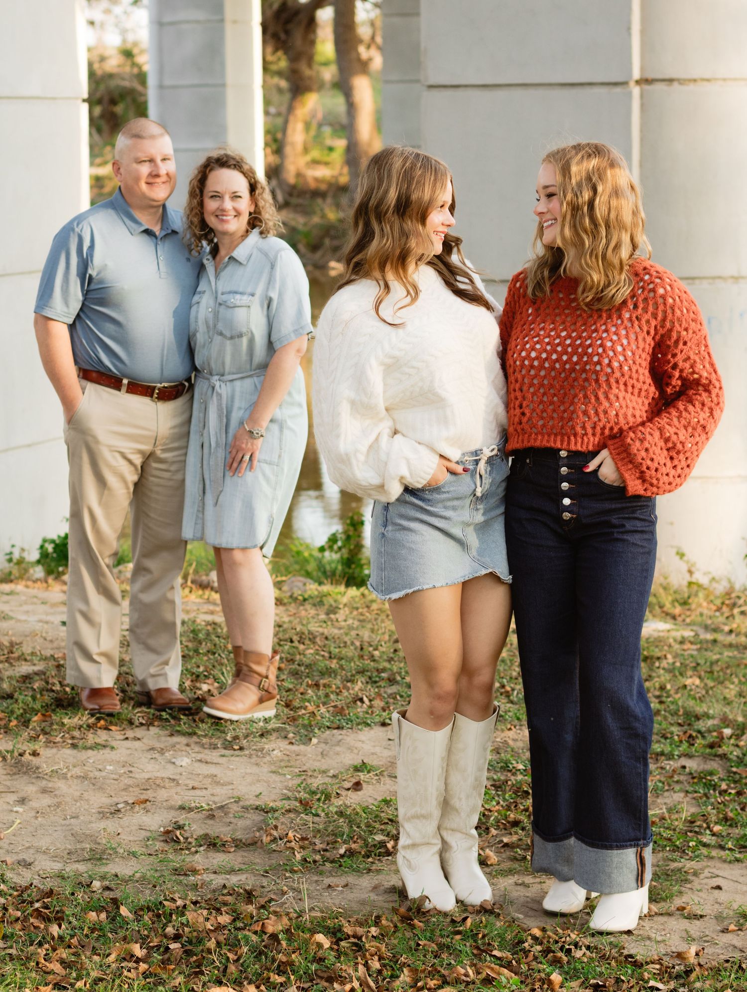 A family smiles during a photo shoot at San Gabriel Park in Georgetown, Texas.
