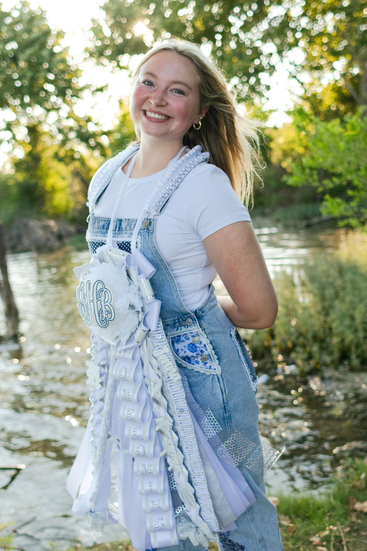 A high school senior poses with her Homecoming mum in Texas.