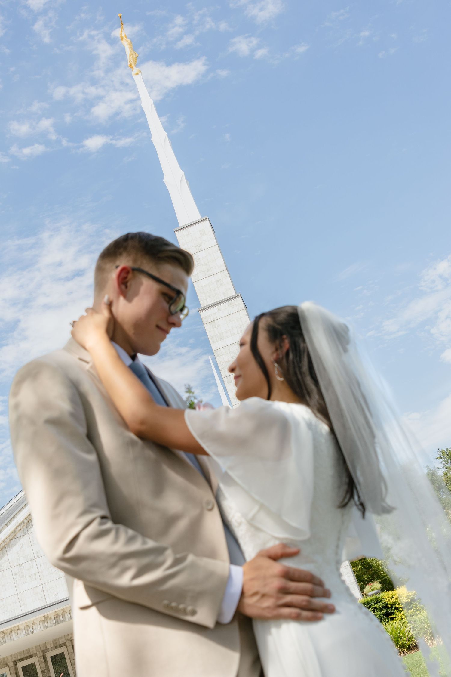 A bride and groom hold each other at a church temple in Texas on their wedding day.