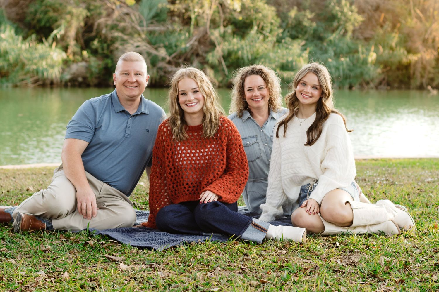 A family smiles during a photo shoot at San Gabriel Park in Georgetown, Texas.