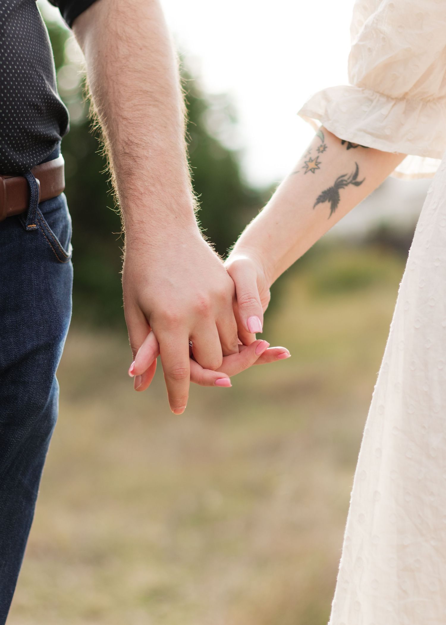 A couple holds hands near a lake in Austin, Texas.