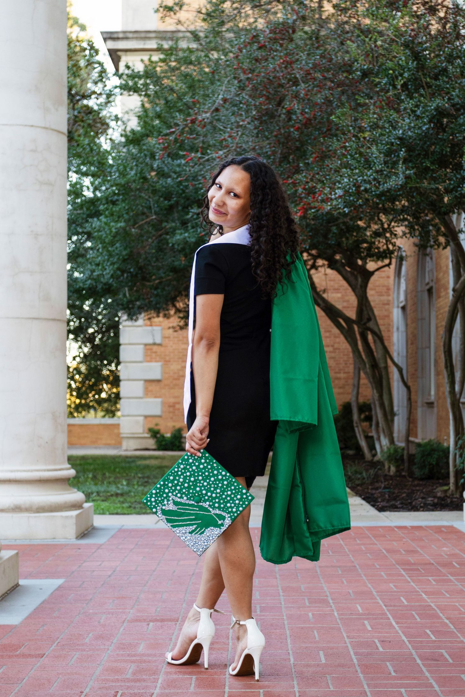 A college student wears her graduation memorabilia on campus.