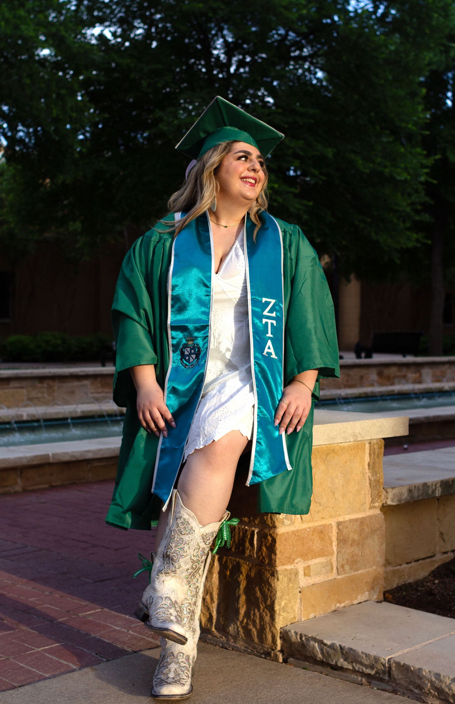 A college student wears her graduation memorabilia on campus.