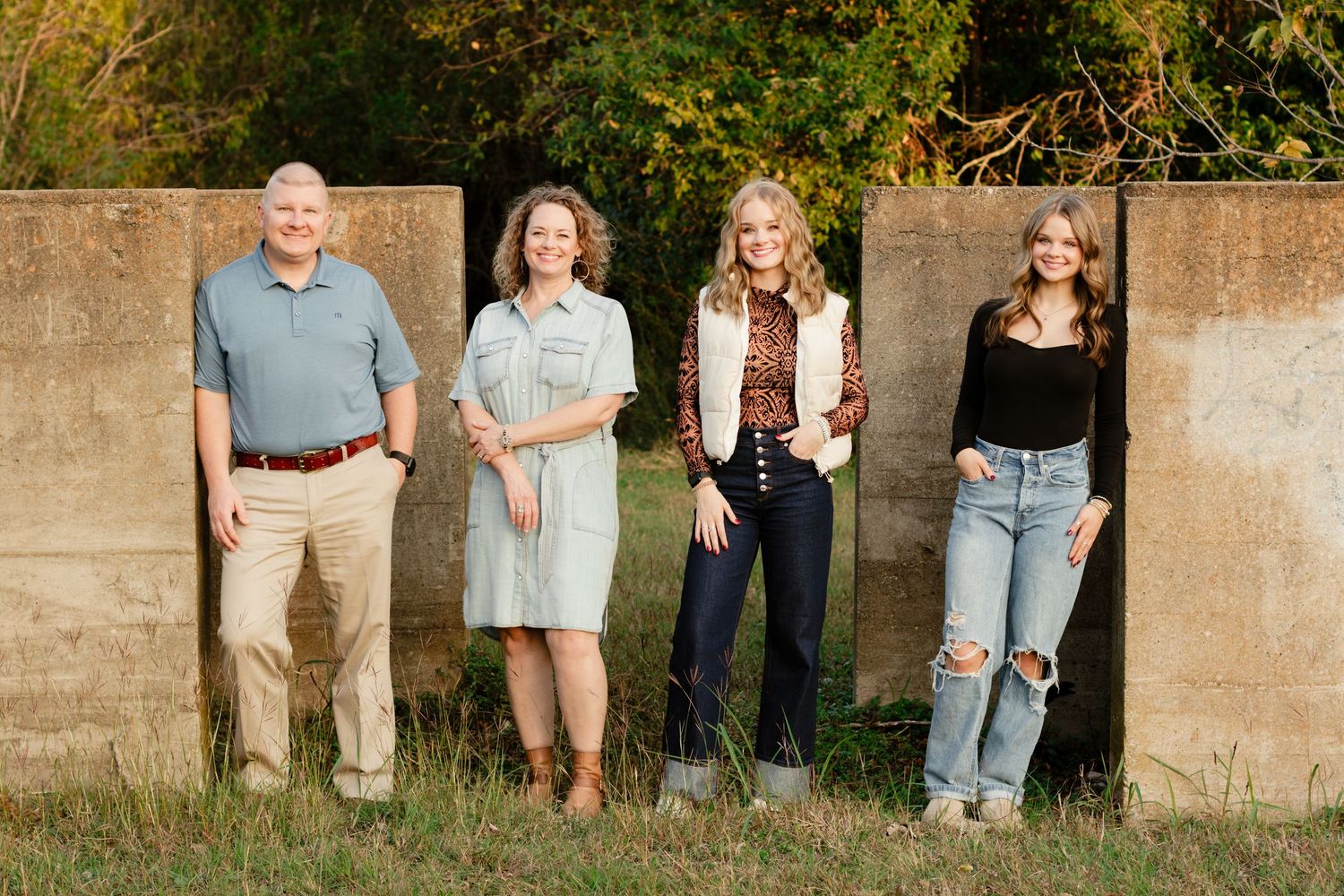 A family smiles during a photo shoot at an abandoned building in Georgetown, Texas.