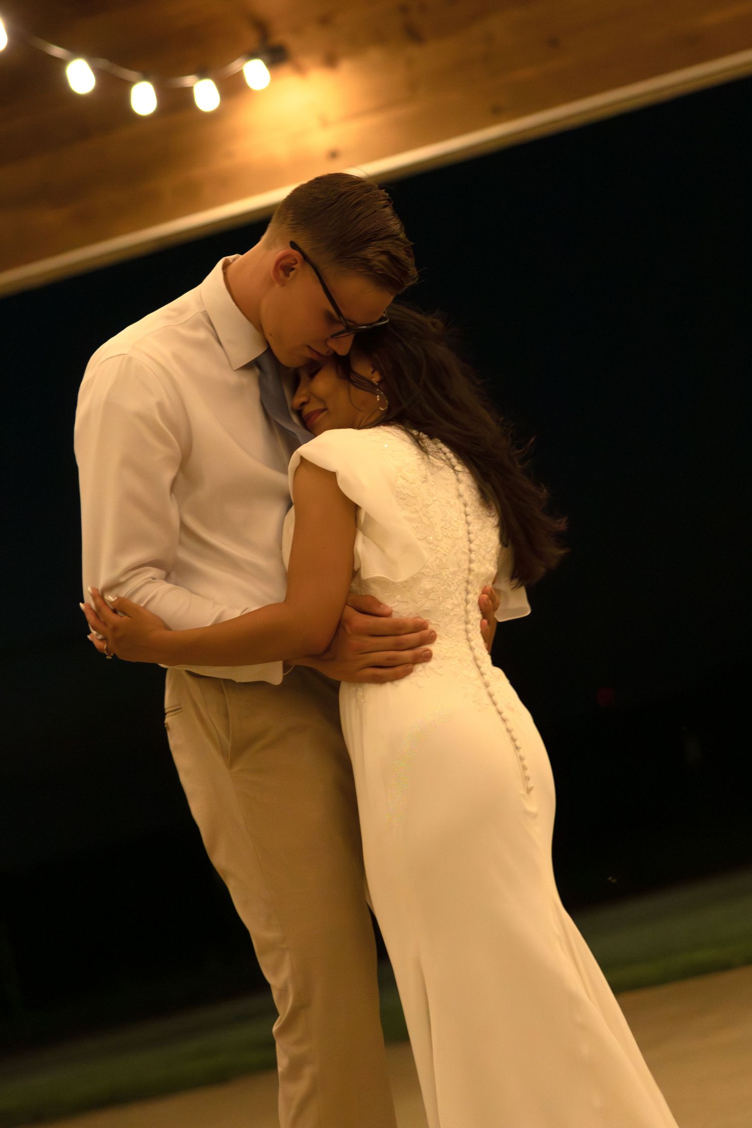 A bride and groom dance together at a wedding venue in Collinsville, Texas.