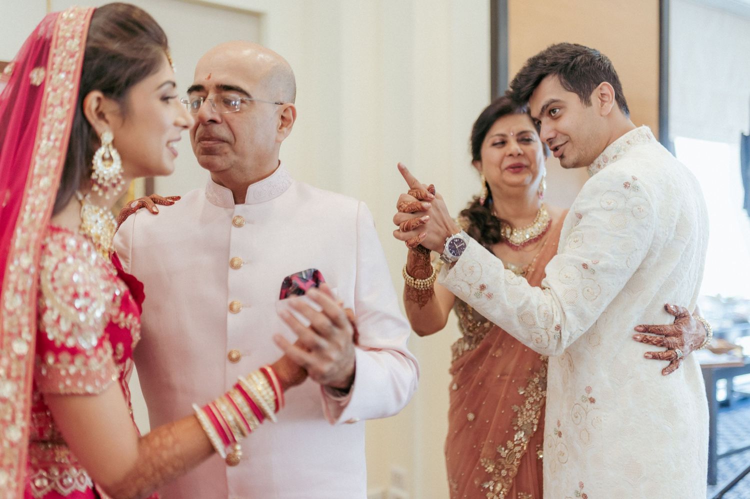Indian bride and groom receive blessings from family members during traditional wedding ceremony.